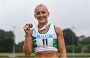 29 June 2024; Sarah Lavin of Emerald AC, Limerick, with her gold medal after competing in the women's 100m hurdles during day one of the 123.ie National Outdoor Senior Championships at Morton Stadium in Santry, Dublin. Photo by Tyler Miller/Sportsfile