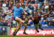 29 June 2024; Brian Fenton of Dublin kicks a point despite the attention of John Maher of Galway during the GAA Football All-Ireland Senior Championship quarter-final match between Dublin and Galway at Croke Park in Dublin. Photo by Harry Murphy/Sportsfile