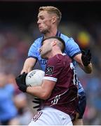 29 June 2024; Séan Mulkerrin of Galway is tackled by Paul Mannion of Dublin during the GAA Football All-Ireland Senior Championship quarter-final match between Dublin and Galway at Croke Park in Dublin. Photo by Shauna Clinton/Sportsfile