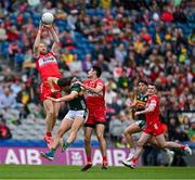 30 June 2024; Conor Glass of Derry catches a kickout ahead of teammate Christopher McKaigue and David Clifford of Kerry during the GAA Football All-Ireland Senior Championship quarter-final match between Kerry and Derry at Croke Park in Dublin. Photo by Brendan Moran/Sportsfile