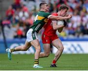 30 June 2024; Eoin McEvoy of Derry is tackled by Sean O'Shea of Kerry during the GAA Football All-Ireland Senior Championship quarter-final match between Kerry and Derry at Croke Park in Dublin. Photo by Shauna Clinton/Sportsfile