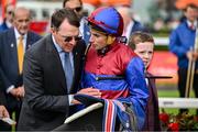 30 June 2024; Trainer Aidan O'Brien with the winning jockey Ryan Moore after the Dubai Duty Free Irish Derby Group 1 on day three of the Dubai Duty Free Irish Derby Festival at The Curragh Racecourse in Kildare. Photo by David Fitzgerald/Sportsfile