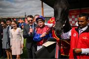 30 June 2024; Jockey Ryan Moore, with horse Los Angeles and trainer Aidan O'Brien celebrate after winning the Dubai Duty Free Irish Derby Group 1 on day three of the Dubai Duty Free Irish Derby Festival at The Curragh Racecourse in Kildare. Photo by David Fitzgerald/Sportsfile