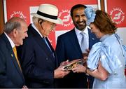 30 June 2024; Winning owner John Magnier, second from left, looking at the plate after the Dubai Duty Free Irish Derby Group 1 on day three of the Dubai Duty Free Irish Derby Festival at The Curragh Racecourse in Kildare. Photo by David Fitzgerald/Sportsfile