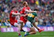 30 June 2024; David Clifford of Kerry is tackled by Conor Glass, right, and Gareth McKinless of Derry during the GAA Football All-Ireland Senior Championship quarter-final match between Kerry and Derry at Croke Park in Dublin. Photo by Shauna Clinton/Sportsfile