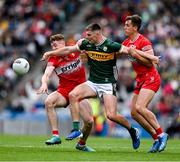 30 June 2024; Diarmuid O'Connor of Kerry is tackled by Lachlan Murray, left, and Shane McGuigan of Derry during the GAA Football All-Ireland Senior Championship quarter-final match between Kerry and Derry at Croke Park in Dublin. Photo by Brendan Moran/Sportsfile