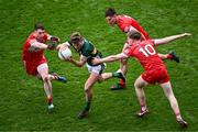 30 June 2024; Gavin White of Kerry in action against Derry players, from left, Gareth McKinless, Conor Doherty and Ethan Doherty during the GAA Football All-Ireland Senior Championship quarter-final match between Kerry and Derry at Croke Park in Dublin. Photo by Piaras Ó Mídheach/Sportsfile
