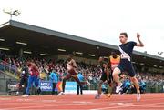 9 July 2024; Coby Hilton of USA, right, crosses the finish the line to win the SuperValu 100m men's race final during the Cork City Sports at MTU Athletics Track in Cork. Photo by Tyler Miller/Sportsfile