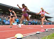 9 July 2024; Renee Regis of Great Britain, centre, crosses the finish line to finish third ahead of Phil Healy of Ireland, left, and Molly Scott of Ireland, in the Centra 100m women's final during the Cork City Sports at MTU Athletics Track in Cork. Photo by Tyler Miller/Sportsfile