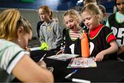 10 July 2024; Rachael Darragh signs autographs for twin sisters Sarah, left, and Grace McGrath, age 8, from Dublin during the Team Ireland Paris 2024 team training for Badminton at the National Indoor Arena on the Sport Ireland Campus in Dublin. Photo by David Fitzgerald/Sportsfile