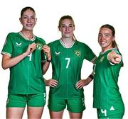 9 July 2024; Republic of Ireland players, from left, Kate Thompson, Ellen Dolan and Meabh Russell during a Republic of Ireland Women's Under-19 squad portrait session at the Pillo Hotel in Ashbourne, Meath. Photo by Ben McShane/Sportsfile