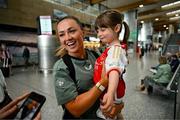 13 July 2024; Republic of Ireland's Katie McCabe with supporter Georgie Ring, age 4, from Carrigaline, Cork, on the teams arrival at Cork Airport ahead of their 2025 UEFA Women's European Championship Qualifier match against France at Páirc Uí Chaoimh in Cork. Photo by Stephen McCarthy/Sportsfile