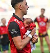13 July 2024; Ryan Johnston of Down celebrates with with his daughter Thea, 1 month old, after victory in the Tailteann Cup Final match between Down and Laois at Croke Park in Dublin. Photo by Piaras Ó Mídheach/Sportsfile