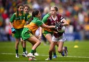 14 July 2024; Jessica Hassett, Knockanean NS, Ennis, Clare, representing Galway, in action against Ellie Selfridge, St Brigid's PS, Magherafelt, Derry, representing Donegal, during the GAA INTO Cumann na mBunscol Respect Exhibition Go Games at the GAA Football All-Ireland Senior Championship semi-final match between Donegal and Galway at Croke Park in Dublin. Photo by Seb Daly/Sportsfile