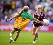 14 July 2024; Katie Grimes, St Joseph's PS, Ballinrobe, Mayo, representing Galway, in action against Sadhbh Ní Eachaí, GS Eiscir Riada, Leacmhcán, Áth Cliath, representing Donegal, during the GAA INTO Cumann na mBunscol Respect Exhibition Go Games at the GAA Football All-Ireland Senior Championship semi-final match between Donegal and Galway at Croke Park in Dublin. Photo by Seb Daly/Sportsfile