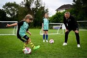 15 July 2024; Participant Kiera Cano shows Republic of Ireland manager Heimir Hallgrímsson during a visit to a FAI football camp at Verona FC in Blanchardstown, Dublin. Photo by Harry Murphy/Sportsfile