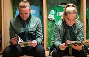 16 July 2024; Courtney Brosnan, left, and Jessie Stapleton of Republic of Ireland read the match programme in the dressingroom before the 2025 UEFA Women's European Championship qualifying group A match between Republic of Ireland and France at Páirc Uí Chaoimh in Cork. Photo by Stephen McCarthy/Sportsfile