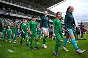 16 July 2024; Republic of Ireland goalkeeper Courtney Brosnan, right, and Louise Quinn with mascots before the 2025 UEFA Women's European Championship qualifying group A match between Republic of Ireland and France at Páirc Uí Chaoimh in Cork. Photo by Stephen McCarthy/Sportsfile