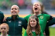 16 July 2024; Denise O'Sullivan, left, and Ruesha Littlejohn of Republic of Ireland sing Amhrán na bhFiann before the 2025 UEFA Women's European Championship qualifying group A match between Republic of Ireland and France at Páirc Uí Chaoimh in Cork. Photo by Stephen McCarthy/Sportsfile