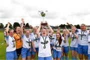 21 July 2024; Sarah Ryan captain of Eastern Women’s Football League lifts the Angela Hearst Cup as her team-mates celebrate after the FAI Women’s Angela Hearst Inter-League Cup final match between Waterford Women’s League and Eastern Women’s Football League at Arklow Town FC in Wicklow. Photo by Matt Browne/Sportsfile