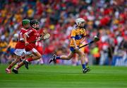 21 July 2024; Darragh Pettitt, Murrintown NS, Murrintown, Wexford, representing Clare races clear of Liam Meade, Ballyfin NS, Ballyfin, Laois, representing Cork amd Shay Mallie, Scoil Mhuire na mBuachaillí, Monaghan, representing Cork during the GAA INTO Cumann na mBunscol Respect Exhibition Go Games at the GAA Hurling All-Ireland Senior Championship final between Clare and Cork at Croke Park in Dublin. Photo by Ray McManus/Sportsfile