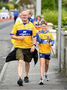 22 July 2024; Clare supporters Tommy Dillon and his son Noah make their way to the homecoming celebrations of the All-Ireland Senior Hurling Champions at Active Ennis Tim Smythe Park in Clare. Photo by John Sheridan/Sportsfile