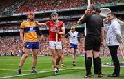 21 July 2024; Darragh Fitzgibbon of Cork and John Conlon of Clare jostle as referee Johnny Murphy discusses a decision with his umpires during the GAA Hurling All-Ireland Senior Championship Final between Clare and Cork at Croke Park in Dublin. Photo by Sam Barnes/Sportsfile
