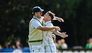 25 July 2024; Curtis Campher of Ireland celebrates with Mark Adair after taking the wicket of Prince Masvaure during day one of the Test Match between Ireland and Zimbabwe at Stormont in Belfast. Photo by Oliver McVeigh/Sportsfile