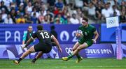 25 July 2024; Hugo Keenan of Team Ireland in action against Joe Webber of Team New Zealand during the Men's Rugby Sevens Pool A match between Team Ireland and Team New Zealand at the Stade de France during the 2024 Paris Summer Olympic Games in Paris, France. Photo by Brendan Moran/Sportsfile