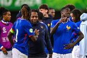 25 July 2024; France head coach Bernard Diomede, centre, celebrates with Valentin Atangana of France, left, after the UEFA European U19 Championship semi-final match between France and Ukraine at National Football Stadium at Windsor Park in Belfast, Northern Ireland. Photo by Ben McShane/Sportsfile