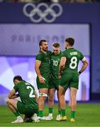 25 July 2024; Team Ireland players, from left, Andrew Smith, Harry McNulty, Terry Kennedy and Hugo Keenan after defeat in the Men's Rugby Sevens Quarter-Final match between Team Fiji and Team Ireland at the Stade de France during the 2024 Paris Summer Olympic Games in Paris, France. Photo by Brendan Moran/Sportsfile