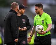 26 July 2024; Referee Eoghan O'Shea in conversation with Bohemians assistant manager Stephen O'Donnell, centre, and Bohemians manager Alan Reynolds as they leave the pitch at half-time during the SSE Airtricity Men's Premier Division match between Bohemians and Dundalk at Dalymount Park in Dublin. Photo by Seb Daly/Sportsfile