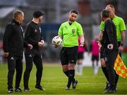 26 July 2024; Referee Eoghan O'Shea in conversation with, from left, Bohemians manager Alan Reynolds, Bohemians assistant manager Stephen O'Donnell, and Bohemians first team coach Derek Pender as they leave the pitch at half-time during the SSE Airtricity Men's Premier Division match between Bohemians and Dundalk at Dalymount Park in Dublin. Photo by Seb Daly/Sportsfile