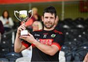 27 July 2024; Christopher Kearns of Naomh Colum Cille holds aloft the cup after the CúChulainn Hurling League Division Two Ulster Final match between Omagh St Enda’s and Naomh Colum Cille at Healy Park in Omagh, Tyrone. Photo by Oliver McVeigh/Sportsfile