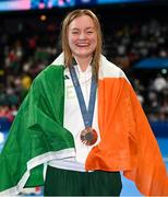 29 July 2024; Women's 100m breaststroke final bronze medallist Mona McSharry of Team Ireland celebrates with her medal at the Paris La Défense Arena during the 2024 Paris Summer Olympic Games in Paris, France. Photo by Stephen McCarthy/Sportsfile