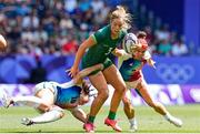 30 July 2024; Stacey Flood of Team Ireland is tackled by Caroline Drouin, left, and Camille Grassineau of Team France during the Women's Rugby Sevens placing 5-8 match between Team Ireland and Team France at the Stade de France during the 2024 Paris Summer Olympic Games in Paris, France. Photo by Hugo Pfeiffer/Sportsfile