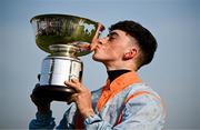 30 July 2024; Jockey Wayne Hassett kisses the trophy after sending out Mexicali Rose to win the COLM QUINN BMW Mile Handicap on day two of the Galway Races Summer Festival at Ballybrit Racecourse in Galway. Photo by Harry Murphy/Sportsfile