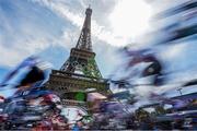 4 August 2024; The peloton passes the Eiffel Tower during the women's road race during the 2024 Paris Summer Olympic Games in Paris, France. Photo by Ed Sykes/Sportsfile