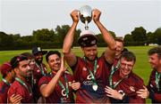 18 August 2024; Rush captain Jarred Barnes and temmates celebrate with the National Cup after the Butlers National Cup final match between Rush and Strabane at The Mardyke in Cork. Photo by Tom Beary/Sportsfile