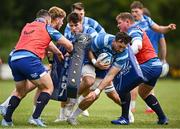 22 August 2024; Jack Conan, centre, is tackled by teammates, from left, Cian Healy, Joe McCarthy and Tadhg Furlong during a Leinster Rugby squad open training session at Gorey RFC in Wexford. Photo by Seb Daly/Sportsfile