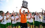 24 August 2024; Cabinteely captain Niamh Haskins lift the trophy alongside teammates after their side's victory in the FAI Women’s Amateur Shield Final match between Cabinteely and Dungarvan United at Travers Insurances Park in Arklow, Wicklow. Photo by Seb Daly/Sportsfile