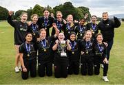 25 August 2024; Phoenix players celebrate with the trophy after their side's victory in the Butlers Women's All-Ireland T20 Cup Final match between Phoenix and Waringstown at Phoenix Park in Dublin. Photo by Seb Daly/Sportsfile