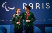 6 September 2024; Katie-George Dunlevy, right, and pilot Linda Kelly of Ireland celebrate with their silver medals after the Women's B road race on day nine of the Paris 2024 Paralympic Games at Clichy-sous- Bois in Paris, France. Photo by Harry Murphy/Sportsfile