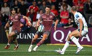 6 September 2024; Billy Burns of Munster chips past Max Llewyllyn of Gloucester during the  pre-season friendly match between Munster and Gloucester at Virgin Media Park in Cork. Photo by Brendan Moran/Sportsfile