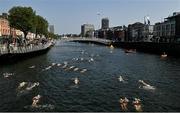 7 September 2024; Participants in the senior women's race pass under the Ha'penny Bridge during the 104th Dublin City Liffey Swim hosted by Swim Ireland. Photo by Piaras Ó Mídheach/Sportsfile