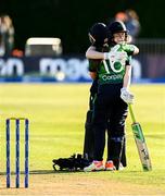 15 September 2024; Ireland players Leah Paul and Christina Coulter Reilly, behind, celebrate after their side's victory in match two of the Women's T20 International Series between Ireland and England at Clontarf in Dublin. Photo by Piaras Ó Mídheach/Sportsfile