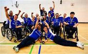 22 September 2024; The Munster team, including captain Darren Dineen, front right, lift the cup after their side's victory in the 2024 M. Donnelly GAA Wheelchair Hurling / Camogie All-Ireland Finals at SETU Carlow Campus Sports Hall in Carlow. Photo by Shauna Clinton/Sportsfile