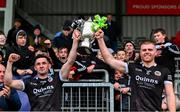 13 October 2024; Kilcoo captains Darryl Branagan, left, and Aaron Morgan lift the cup after their side's victory in the Down County Senior Club Football Championship final match between Burren and Kilcoo at Pairc Esler in Newry, Down. Photo by Shauna Clinton/Sportsfile