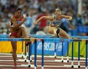 22 August 2004; Ireland's Derval O'Rourke, right, trails Priscilla Lopes of Canada during her 1st round heat of the Women's 100m Hurdles. Olympic Stadium. Games of the XXVIII Olympiad, Athens Summer Olympics Games 2004, Athens, Greece. Picture credit; Brendan Moran / SPORTSFILE