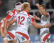 27 September 2013; Luke Marshall, Ulster, 12, celebrates with team-mates Rory Best, partially hidden, and Paul Marshall, right, after scoring his sides first try. Celtic League 2013/14, Round 4, Ulster v Benetton Treviso, Ravenhill, Belfast, Co. Antrim. Picture credit: Oliver McVeigh / SPORTSFILE